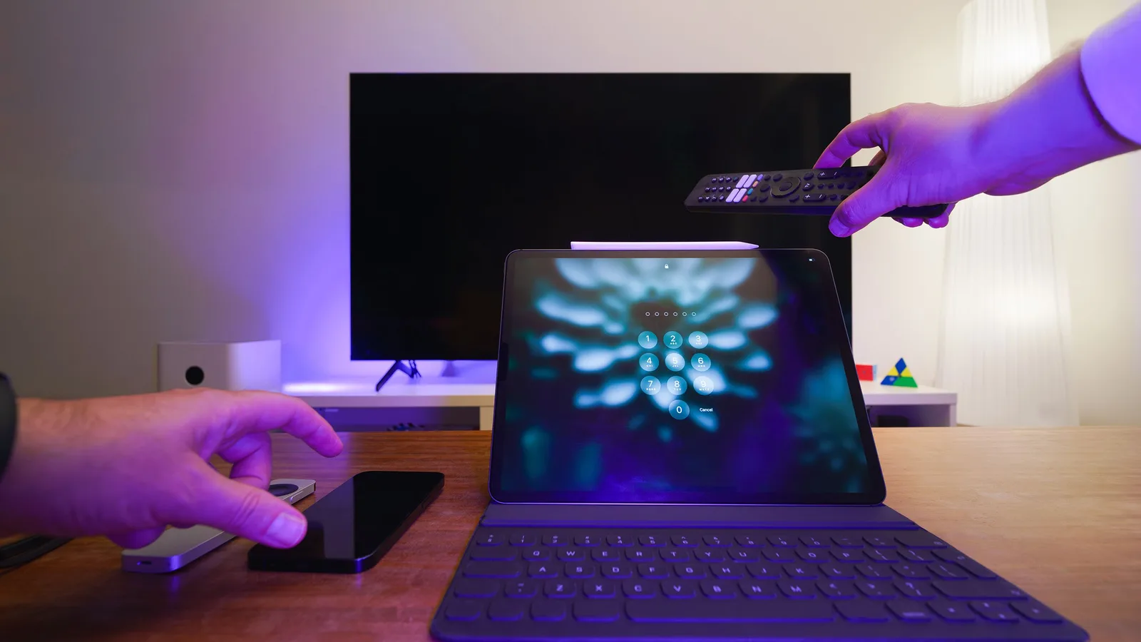 a living room setup featuring a tablet, smartphone, tv, and remote control for managing flash 4k iptv playback