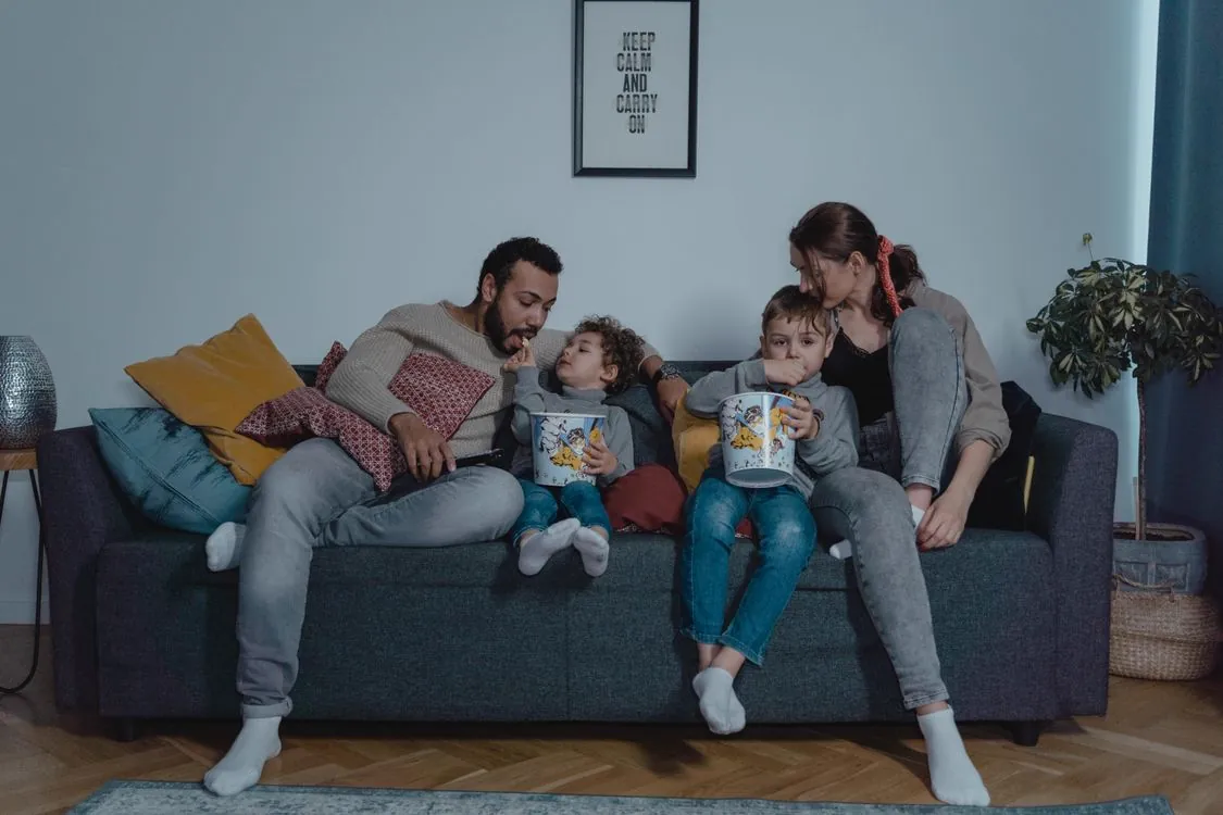 Family home entertainment system with modern living room setup, illustrating scheduled viewing times and balanced screen time for children using IPTV